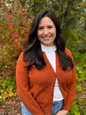 Image of a Latinx woman in an orange sweater